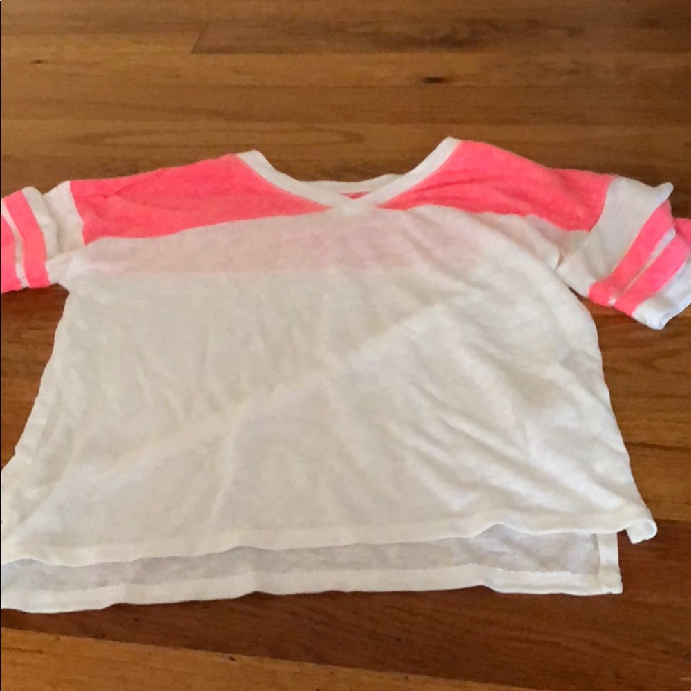 A  white soft tee with pink accents